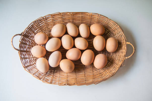 istock straw basket with many chicken eggs on white background 1927768746