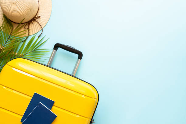 istock Suitcase, hat and flip flops on blue background. 1927790124