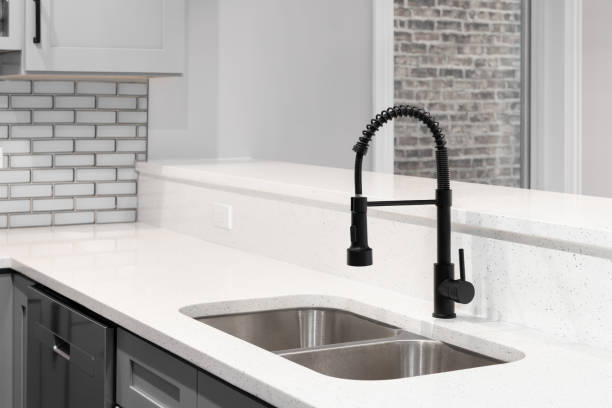 istock A kitchen faucet detail with grey cabinets and subway tile backsplash. 1927816875