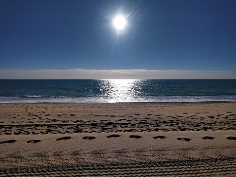 First morning sun over the Mediterranean Sea at Vilassar de Mar Maresme beach, Barcelona in summer. photo