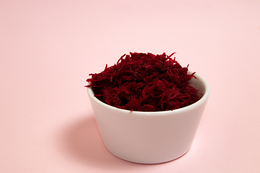 Grated beets in a white bowl