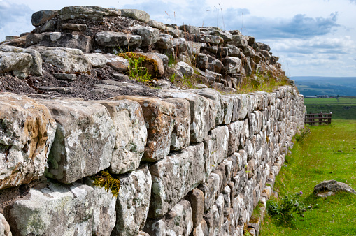 An stile cuts through an ancient dry stone wall near Litton, Derbyshire, UK, a village in the Peak District National Park