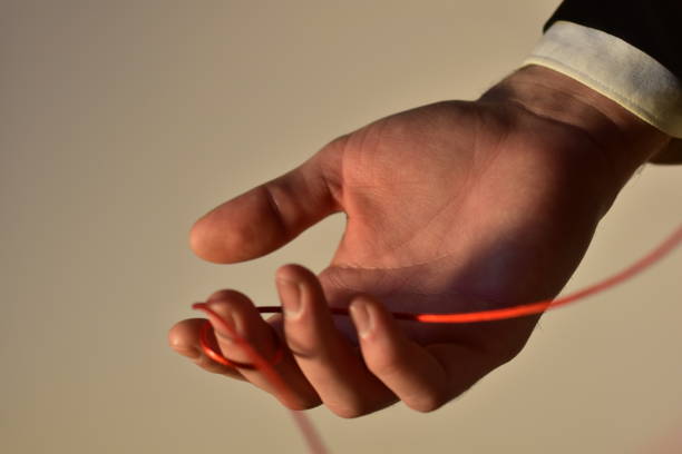 istock Hand in suit hand holding a rope 1927848456