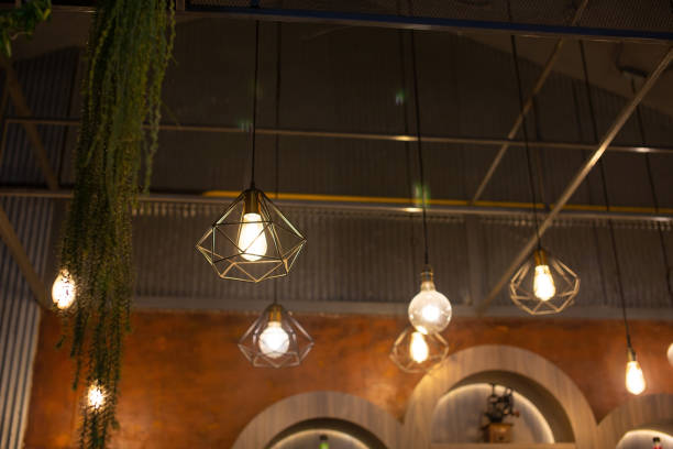istock Several vintage incandescent light bulbs hang from the ceiling. 1927864742