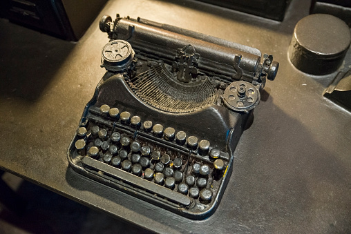 Vintage black typewriter with latin letters close up.