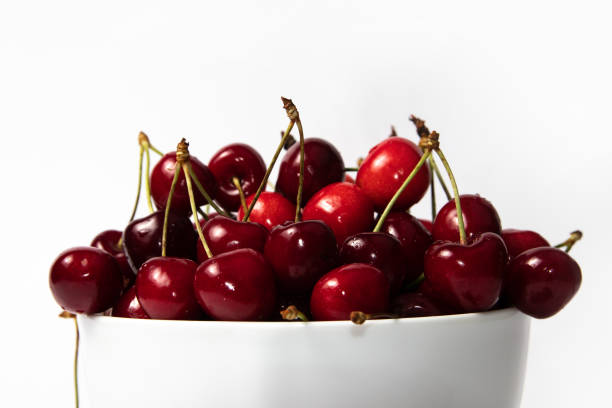 istock Fresh ripe cherries in a white bowl on a white background 1927880932
