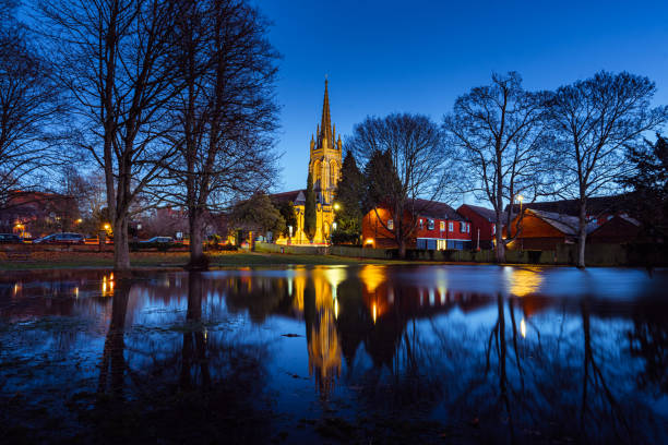 Marlow All Saints Church reflected in flood water amongst trees