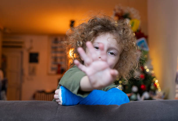 istock Little boy with plaster cast at home 1927882360