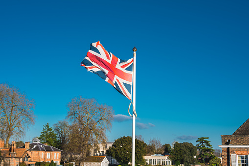 Flag of United Kingdom waving at famous City of Marlow