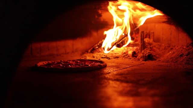Wood is burning in a pizza oven. Close-up