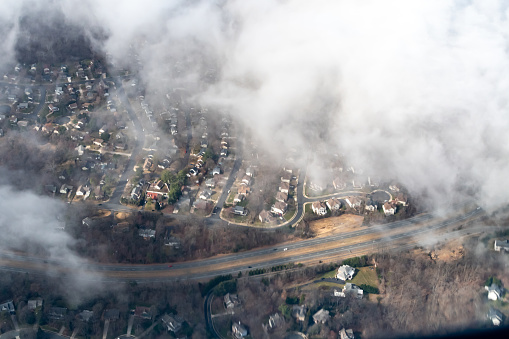 Aerial photograph of suburban areas of Washington DC as seen through clouds from my airplane window