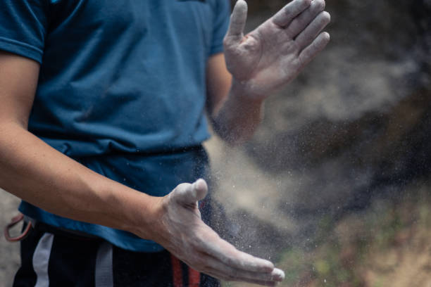 istock Unrecognizable climber put climbing chalk on hands in order to improve friction and grip 1927958051