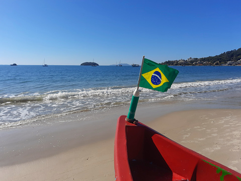 Brazilian flag on the bow of a small boat at Sonho Beach in the state of Santa Catarina in southern Brazil