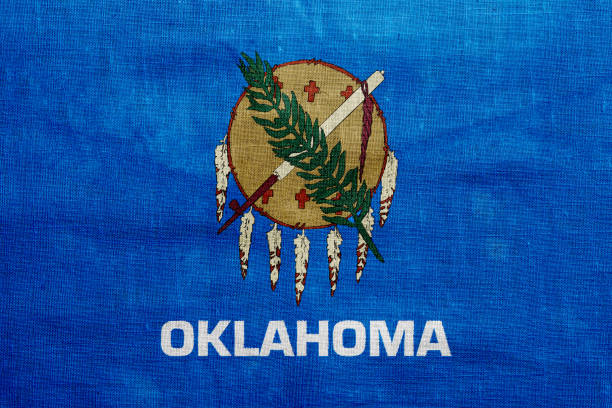 Flag of Oklahoma state USA on a textured background. Concept collage.