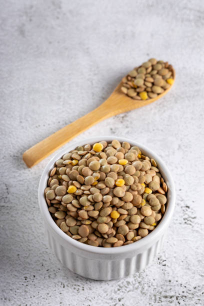 istock Green lentils in the bowl on the table. 1928000445