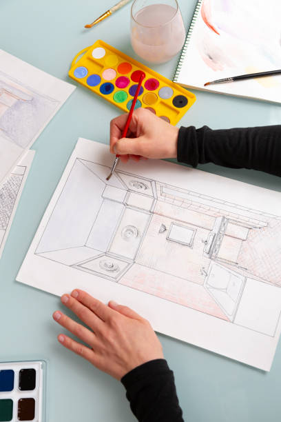 istock Interior designer is working on color hand drawing of bathroom using watercolor paints and brush 1928012617