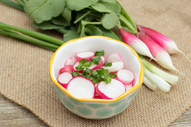 istock Raddish and green onion salad on the rustic wooden table. 1928029089