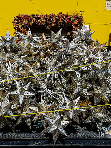 Traditional star shaped lamps made of tin, on the back of a truck at the end of the holiday season. During the Christmas period they have light bulbs inserted and hung across the streets as decorations.