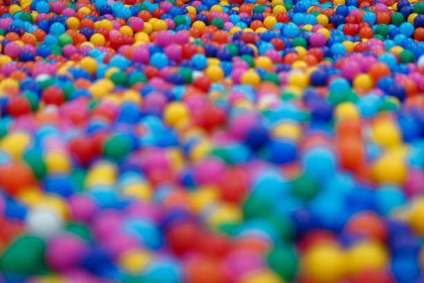 Four years old boy on the ball pool.