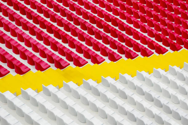 Rows of yellow plastic bleachers on a brick cobblestone.