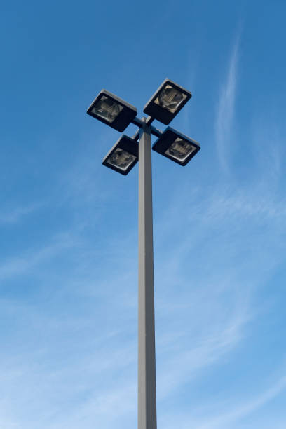 outdoor parking lot light fixture against blue sky - street light parking lot night lot imagens e fotografias de stock