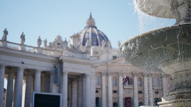 Cinematic view of foiuntain with colonnade of San Pietro. Vatican Rome, water flowing and spray in slow motion