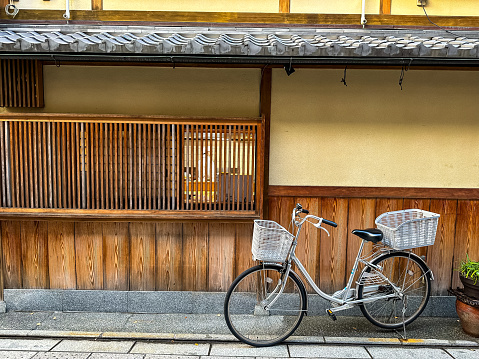 Kyoto, Japan - 09.11.2023. Street view of Gion area in Kyoto, Japan. Narrow alley street in Gion district  with people and old traditional residential wooden buildings. Japanese medieval architecture