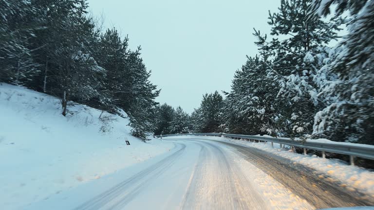 Car drive on slippery winter road covered with snow