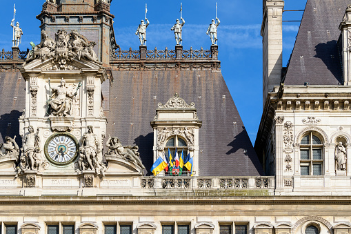 This landscape photo was taken, in Europe, in France, in ile de France, in Paris, on the banks of the Seine, in summer. We see the town hall, under the sun.