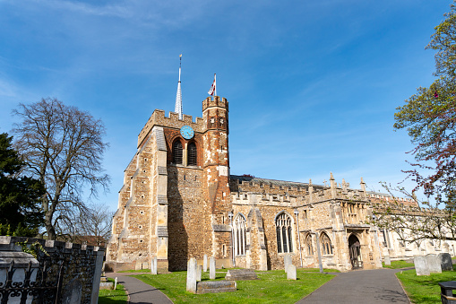 An image of St. Mary's Church in Hitchin, showcasing its historic architecture and the quintessential charm of English parish churches. The church, with its tall spire and classic stone construction, stands as a centerpiece in the community, reflecting the rich heritage and architectural beauty of this Hertfordshire market town.