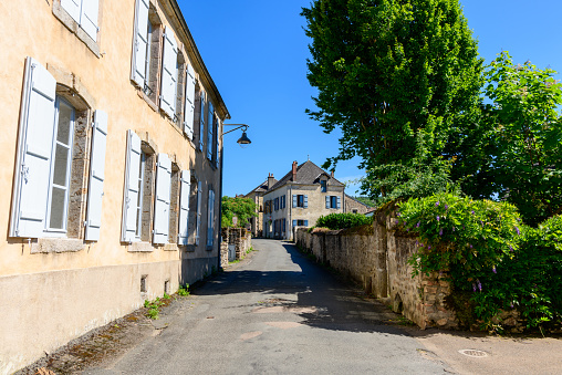 This landscape photo was taken in Europe, in France, in Burgundy, in Nievre, in Larochemillay, towards Chateau Chinon, in summer. We see the old village in the green countryside, under the Sun.