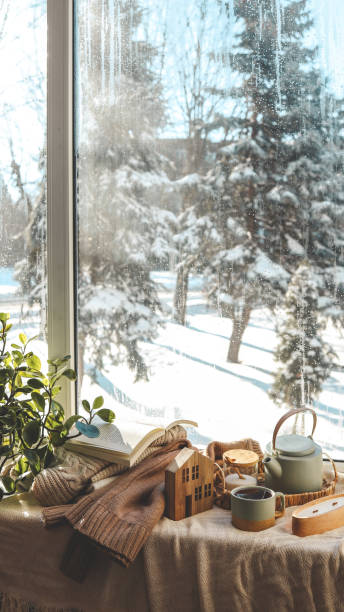 istock Cozy winter photo, stack of sweaters, book, tea and candle 1928344457