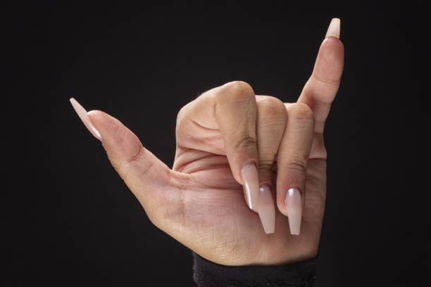 female hands with big nails using fingers to make various signs