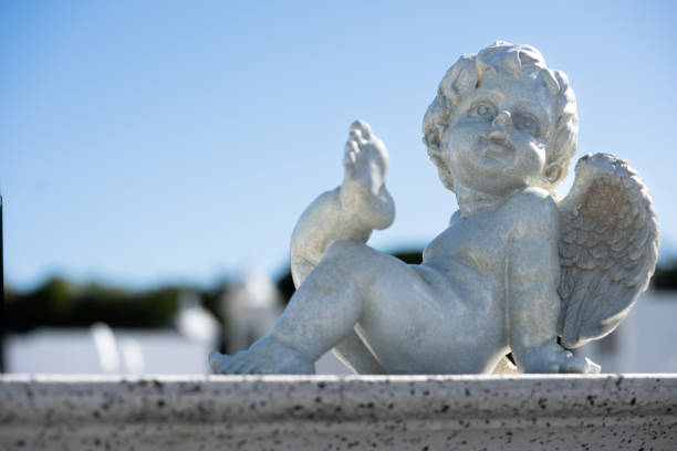 istock angel statue close-up on a clear sky 1928408317