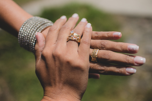 hands of two women wearing their wedding rings