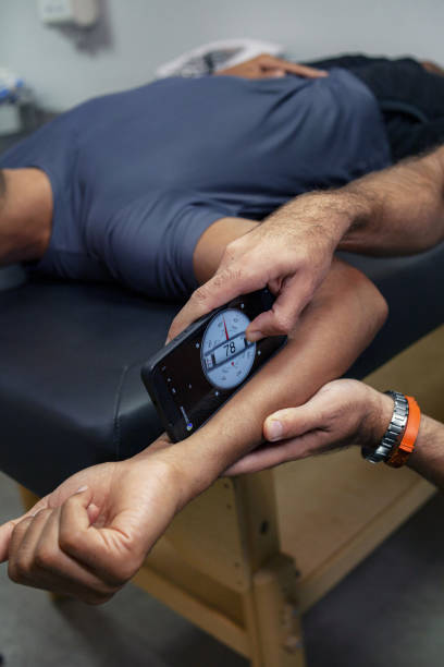 istock Physiotherapist using inclinometer on patient in clinic 1928517050