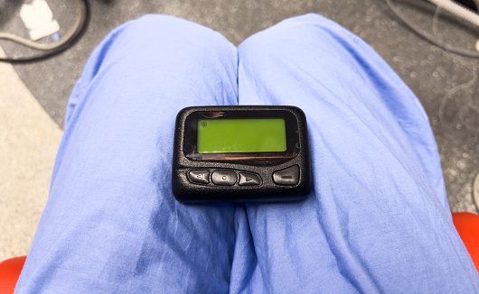 vintage pager on a busy desk, symbolizing hectic work life and essential communication in a hospital setting