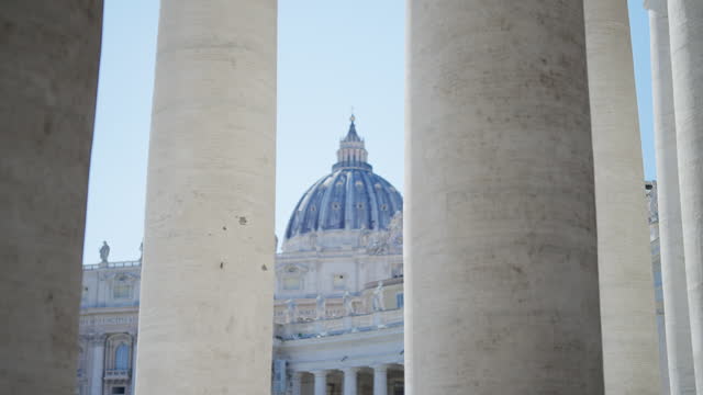 Ciunematic shot of famous colonnade at square with St. Peter's Basilica in Vatican, Rome, Italy, establishing shot
