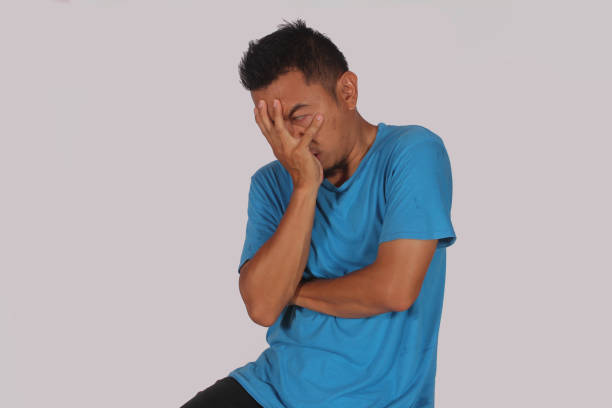 istock Mature Asian man showing disappointed expression by covering face 1928705175