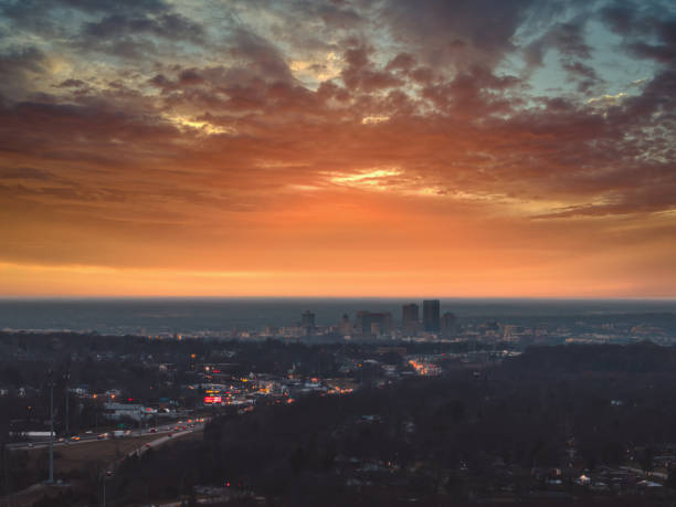 Dayton Sound An aerial view via drone looking west towards downtown Dayton, Ohio at sunset with the sky lit up with colors as the lights come on in the city and surrounding area. dayton ohio skyline stock pictures, royalty-free photos & images