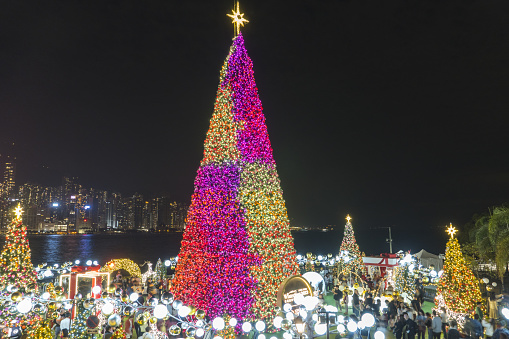 Hong Kong, China - December 30 2023 : Towering Christmas Tree and Festive Displays in the WinterFest 2023 Christmas Event located in West Kowloon Cultural District