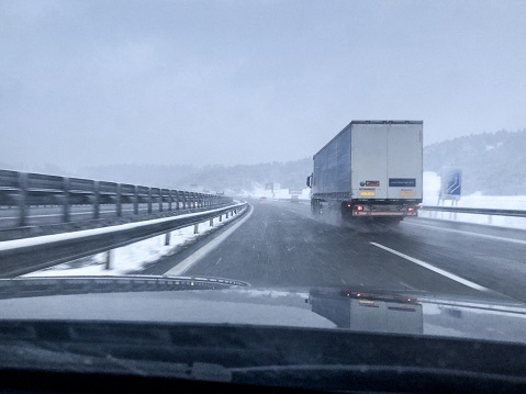 Highway in wintertime - driver's point of view overtaking a truck