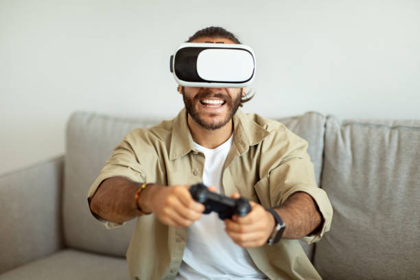 istock Happy young man playing video games at home, using VR 1928848637