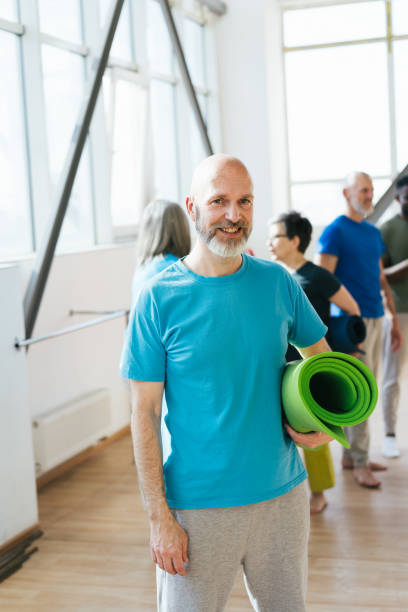 istock Group of senior athletes raise hands to ceiling at workout 1928849692