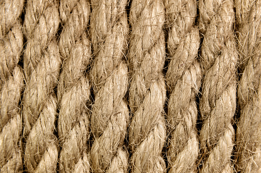 Jute rope in a skein close-up. Background made of natural organic threads. Macro shot. Environmentally friendly Material for creativity. Made from the Corchorus capsularis plant.