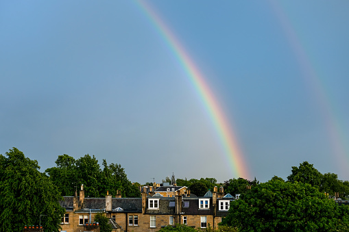 Double Rainbow on Blue Sky after Rain with building in Edinburgh.