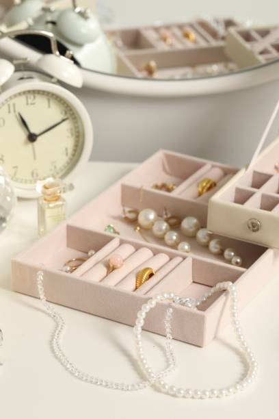 istock Jewelry boxes with many different accessories, perfume and alarm clock on white table 1928958882