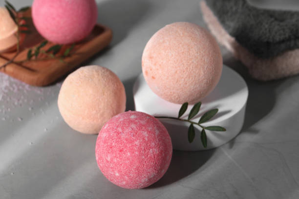istock Beautiful aromatic bath bombs and green twig on grey table 1928991799