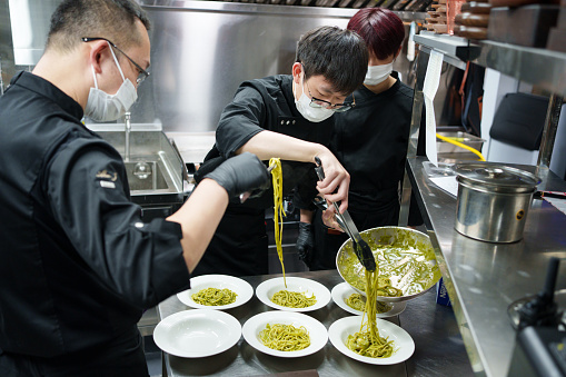 Chef plating pasta
