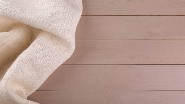 istock Beige burlap fabric on wooden table, top view. Space for text 1929002250